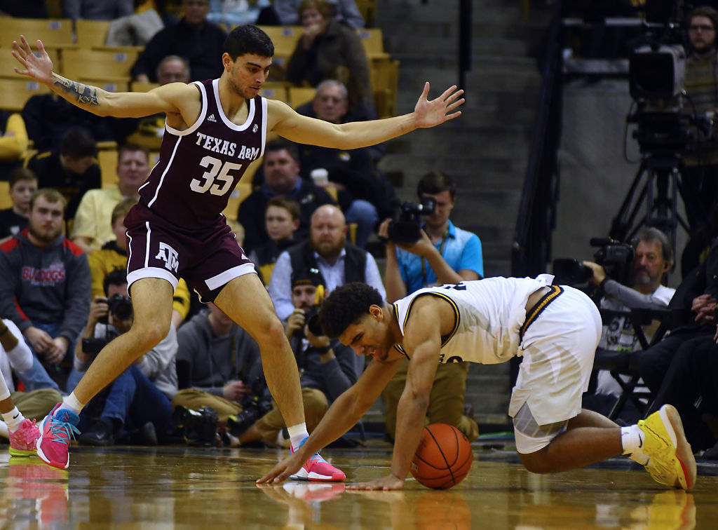Missouri guard Mark Smith falls on the ball while Texas A&M's Yavuz Gultekin